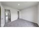 Unfurnished bedroom with neutral walls, grey carpet, and an open closet at 32 Downing Dr, Trafalgar, IN 46181
