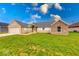 Charming single-story home featuring a brick and stone exterior with a well-manicured lawn and attached garage at 32 Downing Dr, Trafalgar, IN 46181