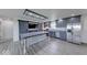 Modern kitchen with gray cabinetry, stainless steel appliances, spacious island, and stylish barn doors at 32 Downing Dr, Trafalgar, IN 46181