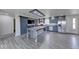 Open-concept kitchen with gray cabinetry, stainless steel appliances, and a spacious island for meal preparation at 32 Downing Dr, Trafalgar, IN 46181