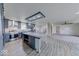 Bright kitchen with gray cabinetry, stainless steel appliances, a spacious island, and an open floor plan at 32 Downing Dr, Trafalgar, IN 46181