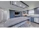 Modern kitchen with gray cabinetry, stainless steel appliances, and a spacious island with countertop at 32 Downing Dr, Trafalgar, IN 46181