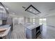 Open floor plan showcasing kitchen with a large gray island and stainless steel appliances at 32 Downing Dr, Trafalgar, IN 46181