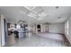 Open concept living space with a fireplace, kitchen, and wood-style gray floors at 32 Downing Dr, Trafalgar, IN 46181