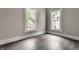 Bedroom with natural light from two windows, complemented by gray walls and modern flooring at 3652 N Kenwood Ave, Indianapolis, IN 46208