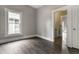 Bedroom with a view into the bathroom, showcasing neutral walls and wood-look flooring at 3652 N Kenwood Ave, Indianapolis, IN 46208