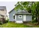 Cozy home exterior with gray siding and a front yard surrounded by greenery at 3652 N Kenwood Ave, Indianapolis, IN 46208