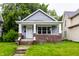 Charming bungalow with a brick-accented porch and fresh gray siding and new landscaping at 3652 N Kenwood Ave, Indianapolis, IN 46208