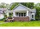 Bungalow-style home features gray siding, brick accents, and a welcoming front porch at 3652 N Kenwood Ave, Indianapolis, IN 46208
