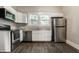 Modern kitchen with stainless steel appliances, white cabinets, and great natural light creating a welcoming atmosphere at 3652 N Kenwood Ave, Indianapolis, IN 46208