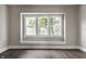 Bright living room with a large window providing natural light and a charming window seat for relaxing and enjoying the view at 3652 N Kenwood Ave, Indianapolis, IN 46208