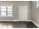 Bright living room featuring gray walls, white trim, new flooring and a view of the neighborhood at 3652 N Kenwood Ave, Indianapolis, IN 46208