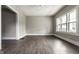 Bright living room with new floors, large windows, ceiling fan and freshly painted gray walls at 3652 N Kenwood Ave, Indianapolis, IN 46208
