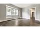 Bright living room with beautiful hardwood floors, natural light from the large bay window, and a view into the next room at 3652 N Kenwood Ave, Indianapolis, IN 46208