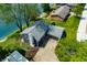 An aerial view of a home with a driveway and a beautiful landscaped yard next to a tranquil lake at 3701 Sandy Hook Dr, Columbus, IN 47203