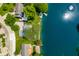 A captivating aerial view of a lakefront property surrounded by lush greenery and serene waters at 3701 Sandy Hook Dr, Columbus, IN 47203