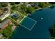 Aerial photograph of a house with lake access and defined property lines, surrounded by greenery at 3701 Sandy Hook Dr, Columbus, IN 47203