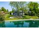 A beautiful home by the water, nestled amongst mature trees. The landscaping is impeccable at 3701 Sandy Hook Dr, Columbus, IN 47203