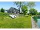 Lakeside property featuring a spacious backyard that gently slopes to the waterfront with a small boat at 3701 Sandy Hook Dr, Columbus, IN 47203