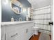 Stylish bathroom with a white vanity, marble countertop, and blue walls at 3701 Sandy Hook Dr, Columbus, IN 47203