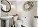 Powder room featuring a pedestal sink, decorative mirrors, and modern fixtures at 3701 Sandy Hook Dr, Columbus, IN 47203