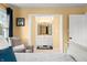 View from the bedroom to the ensuite bathroom with white cabinets and natural light at 3701 Sandy Hook Dr, Columbus, IN 47203