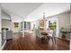 Open-concept living space connecting the dining area to other living areas, natural light, and hardwood floors at 3701 Sandy Hook Dr, Columbus, IN 47203