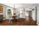 Dining area with a view into the kitchen, showcasing hardwood flooring and a charming chandelier at 3701 Sandy Hook Dr, Columbus, IN 47203