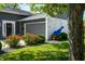 Charming exterior with a tree swing, beautiful landscaping, and a well-maintained lawn at 3701 Sandy Hook Dr, Columbus, IN 47203