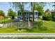 Stunning two-story home with waterfront access and a beautifully landscaped yard with stairs at 3701 Sandy Hook Dr, Columbus, IN 47203