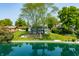 Charming two-story home on the water with mature trees and lush green lawn at 3701 Sandy Hook Dr, Columbus, IN 47203