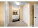Hallway leading to an ensuite bathroom featuring a single vanity and a mirrored medicine cabinet at 3701 Sandy Hook Dr, Columbus, IN 47203