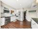 Well-lit kitchen featuring stainless steel appliances, granite countertops, and wooden floors at 3701 Sandy Hook Dr, Columbus, IN 47203