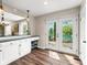 Bright kitchen featuring a breakfast bar and access to a lake view through french doors at 3701 Sandy Hook Dr, Columbus, IN 47203