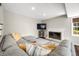 Cozy living room showcasing a fireplace, sectional sofa, and natural light from the window at 3701 Sandy Hook Dr, Columbus, IN 47203