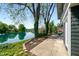 This home's private patio overlooks a serene lake, surrounded by mature trees at 3701 Sandy Hook Dr, Columbus, IN 47203