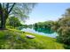 Beautiful waterfront property with lush green lawn and serene water views on a sunny day at 3701 Sandy Hook Dr, Columbus, IN 47203