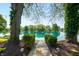 Scenic view of the serene waterfront, framed by lush greenery and mature trees at 3701 Sandy Hook Dr, Columbus, IN 47203