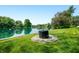 Idyllic waterfront setting featuring a well-maintained lawn and tranquil lake, perfect for relaxation at 3701 Sandy Hook Dr, Columbus, IN 47203