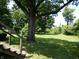 Expansive backyard featuring mature trees and lush green lawn at 4486 Abby Creek Ln, Indianapolis, IN 46205
