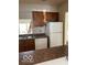 Functional kitchen with stainless steel sink, brown cabinets, and bright white refrigerator at 4486 Abby Creek Ln, Indianapolis, IN 46205