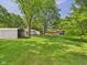 Large backyard with a shed and mature trees, offering privacy and plenty of space at 4733 E 100 S, Anderson, IN 46017