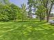 Spacious backyard featuring a well-manicured lawn and mature trees, perfect for outdoor activities at 4733 E 100 S, Anderson, IN 46017