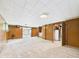 Spacious basement with carpet flooring, paneled walls, and a utility room at 4733 E 100 S, Anderson, IN 46017