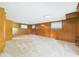 Spacious finished basement with paneled walls, carpet flooring, and natural light at 4733 E 100 S, Anderson, IN 46017