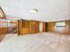 Finished basement featuring neutral carpet, wood paneled walls and access to the upper floors at 4733 E 100 S, Anderson, IN 46017