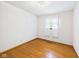 Hardwood bedroom featuring a window with curtains and minimal decor at 4733 E 100 S, Anderson, IN 46017