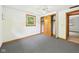 Well-lit bedroom featuring carpet, ceiling fan, closet, and a window with outdoor views at 4733 E 100 S, Anderson, IN 46017