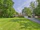 Beautiful home featuring a lush green lawn, mature trees, and well-maintained landscaping at 4733 E 100 S, Anderson, IN 46017