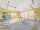 Spacious garage with checkered tile flooring, yellow walls, and artwork at 4733 E 100 S, Anderson, IN 46017